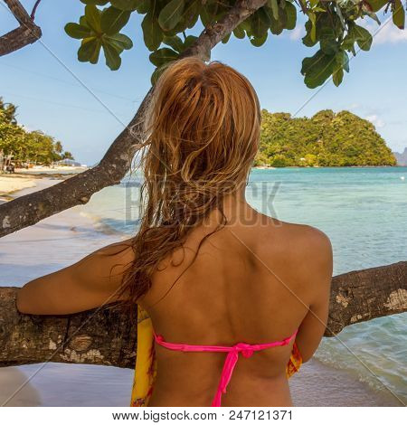 Young Beautiful Girl Body On A Blue Sky Background And The Sea On The Beach. Time For Rest, Happy Wa