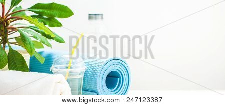Set For Sports. Yoga Mat Towel And A Bottle Of Water On A Light Background The Concept Of A Healthy 