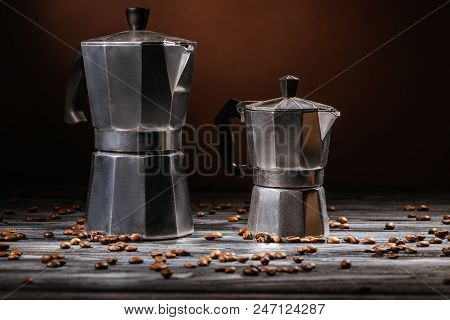 Close-up Shot Of Moka Pots On Rustic Wooden Table Spilled With Coffee