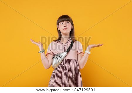 Indefinite. Meditative Charming Girl Wearing Lovely Clothes And Looking At The Ceiling