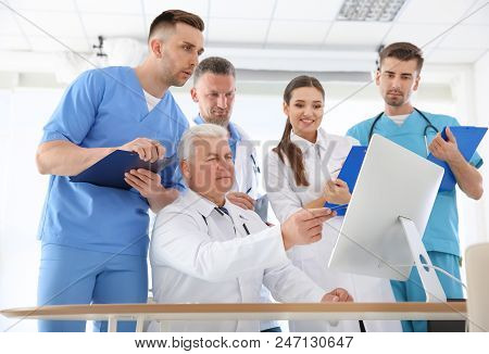 Group Of Doctors Attending Meeting In Clinic. Cardiology Conference