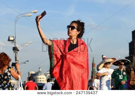 Moscow, Russia - June 26, 2018: Moroccan Football Fan Girl Takes Selfie On The Background Of The Kre