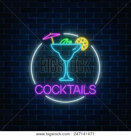 Neon Sambuca Cocktail Sign In Circle Frame On Dark Brick Wall Background. Glowing Gas Advertising Wi