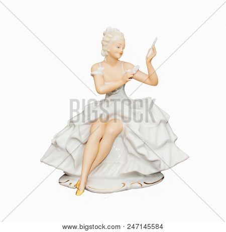 Porcelain figurine of a girl isolated on white background