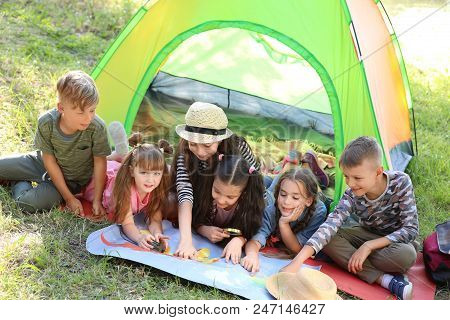 Little Children With Map Near Tent Outdoors. Summer Camp