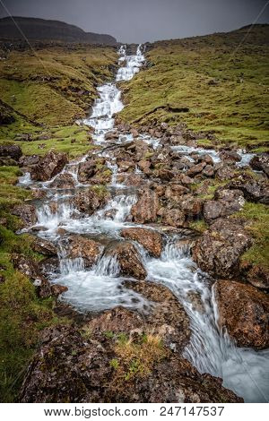 water fall in faroe islands in rainy day