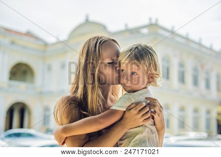 Mom And Son On Background Of Old Town Hall In George Town In Penang, Malaysia. The Foundation Stone 