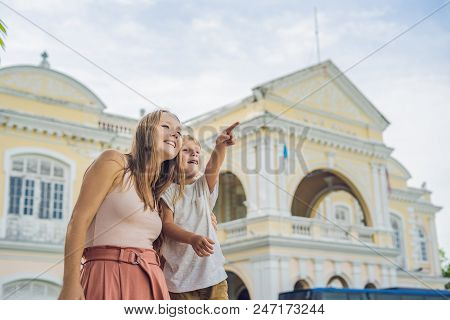Mom And Son On Background Of Old Town Hall In George Town In Penang, Malaysia. The Foundation Stone 