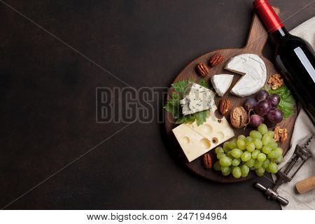 Wine, cheese, grape, bread and nuts. Top view with space for your text