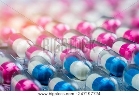 Closeup Pink-white And Blue-white Antibiotics Capsule Pills In Blister Pack. Antimicrobial Drug Resi