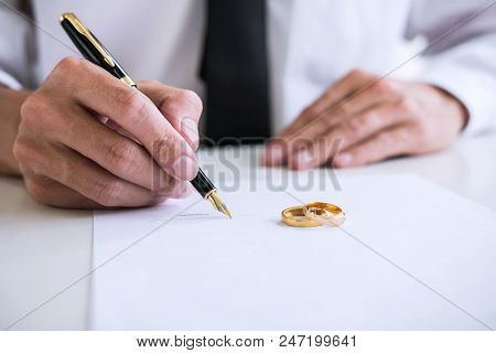 Hands Of Husband Signing Decree Of Divorce (dissolution Or Cancellation) Of Marriage Filing Divorce 