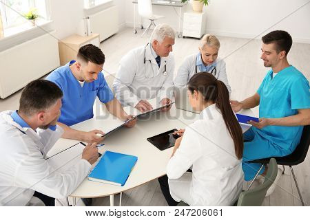 Group Of Doctors Attending Meeting In Clinic. Cardiology Conference