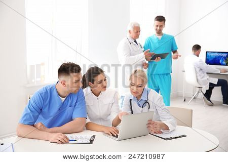 Group Of Doctors Attending Meeting In Clinic. Cardiology Conference
