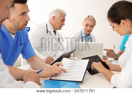 Group Of Doctors Attending Meeting In Clinic. Cardiology Conference