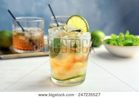 Glass Of Delicious Mint Julep Cocktail On Table