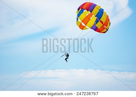 People Playing Parashoot On The Sky Summer Season