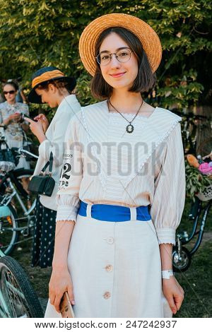 Kiev, Ukraine - May 12, 2018: Girl In Striped Blouse, Button Up Skirt, Glasses And Straw Hat Partici
