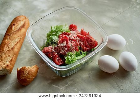 Delicious, Simple And Nutritious Meal. Fresh Tomato Salad, Baguette And Boiled Eggs. On A Gray Backg