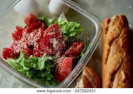 Delicious, Simple And Nutritious Meal. Fresh Tomato Salad, Baguette And Boiled Eggs. On A Gray Backg