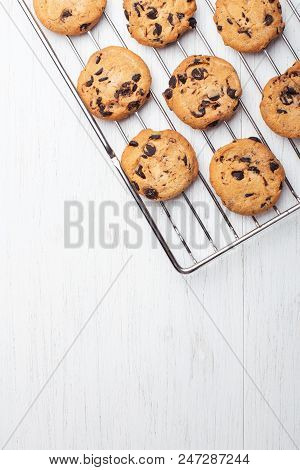 American Cookies With Chocolate Chips On The Grate Fof Oven On White Wooden Background. Top View Wit