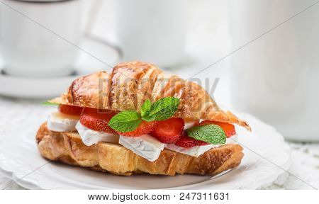 Croissant With Strawberries, Brie Cheese Or Camambert And Mint. Delicious Gourmet Breakfast. Selecti
