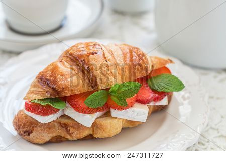 Croissant With Strawberries, Brie Cheese Or Camambert And Mint. Delicious Gourmet Breakfast. Selecti