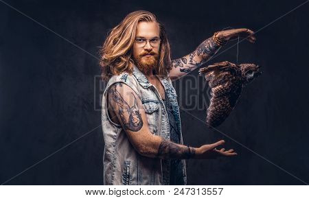 Portrait Of A Tattoed Redhead Hipster Male With Long Luxuriant Hair And Full Beard Dressed In A T-sh