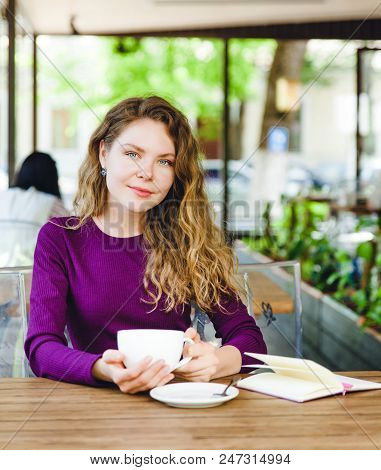 Beautiful Attractive Young Blonde Woman With Curly Hair Drinking Cappuccino And Eating Croissant In 