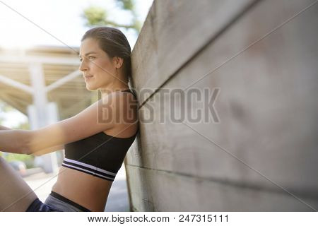 Fitness girl relaxing after exerciing