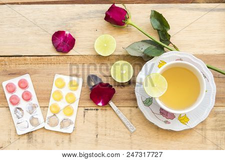 Herbal Health Care Hot Mix Honey Lemon And Cough Sore Throat Pills With Red Rose Flower On Backgroun