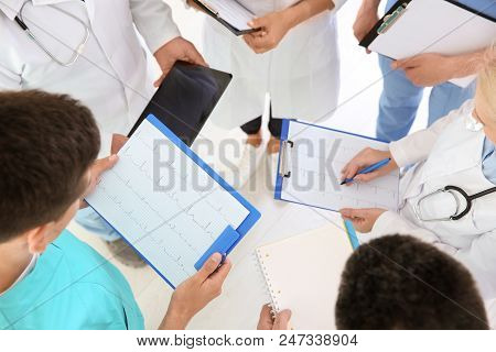 Group Of Doctors Attending Meeting In Clinic. Cardiology Conference