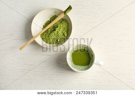 Cup Of Fresh Beverage And Chawan With Powdered Matcha Tea On Wooden Background, Top View