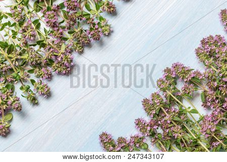 flowering oregano on a wooden table. Place for text