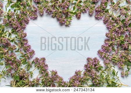 flowering oregano on a wooden table. Place for text