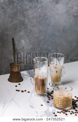Iced Coffee Cocktail Or Frappe With Ice Cubes And Cream Served In Three Different Glasses With Vinta