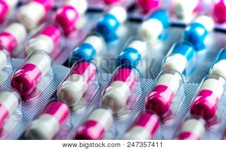 Closeup Pink-white And Blue-white Antibiotics Capsule Pills In Blister Pack. Antimicrobial Drug Resi