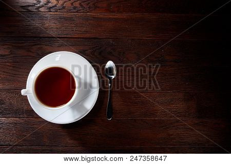Looking Down On A Cup Of Tea Hot Beverage With Cinnamom, Mint Leaves And Fruits Of Star Anise.