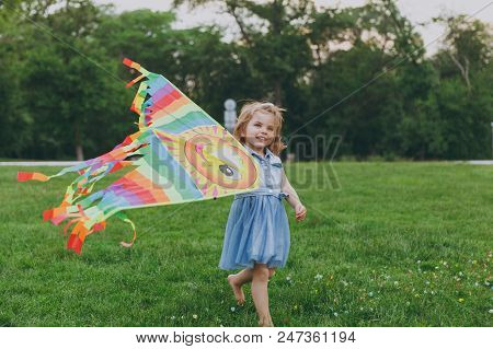 Smiling Little Cute Child Baby Girl In Denim Dress Walking, Play With Colorful Kite And Have Fun In 