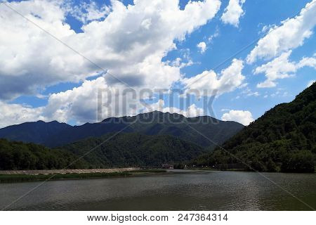 European Route E81 Passing Through Mountains Next To The Olt River In Romania.