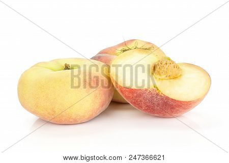 Two Fresh Ripe Saturn Peaches And One Sliced Half Isolated On White Background