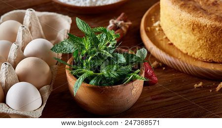 Fresh Mint Leaves In A Bowl On Wooden Table, Close-up, Selective Focus, Shallow Depth Of Field. Mint