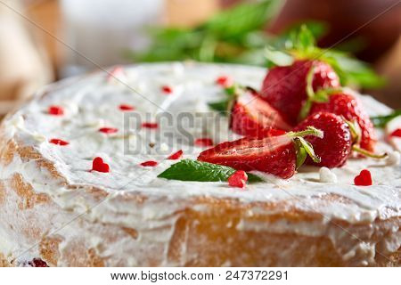 Strawberry Tart Covered With Whipped Sour Cream Surrounded By Organic Ingredients And Kitchen Utensi