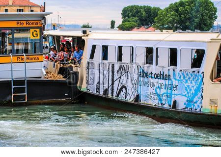 Venice, Italy - June, 28: Regular-route swimming bus on a channel in Venice, Italy