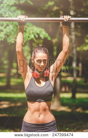 Fitness Woman Preparing For Doing Pullups In Nature. Healthy Lifestyle Concept.
