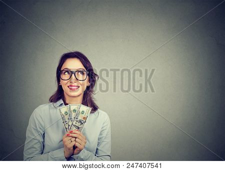 Happy Daydreaming Business Woman With Money Dollar Bills In Hand Imagining How To Spend Them Isolate