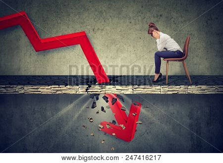 Depressed Business Woman Looking Down At The Falling Red Arrow Going Through A Concrete Floor. Fall 