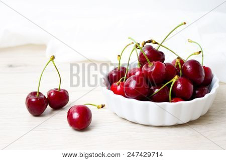 Healthy Eating And Food Concept - Cherries In White Bowl. Cherry On White Background.