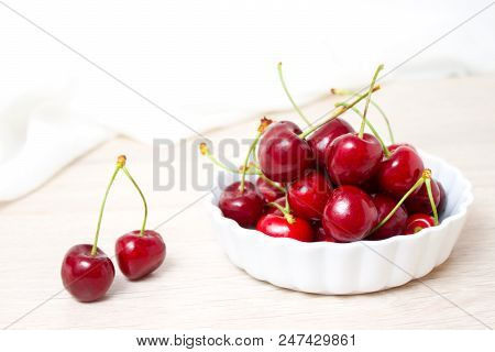 Healthy Eating And Food Concept - Cherries In White Bowl. Cherry On White Background.