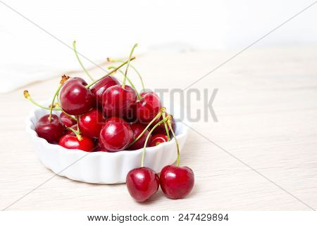 Healthy Eating And Food Concept - Cherries In White Bowl. Cherry On White Background. Copyspace