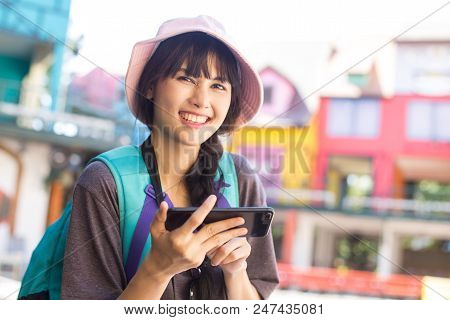 Portrait Of Happy Traveler Woman In City. Asian Women Using Smartphone For Seach Location. Woman Wit